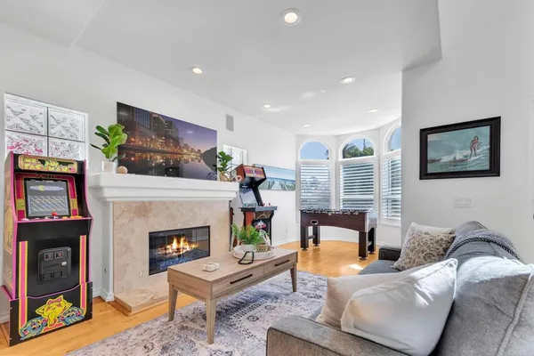 a living room with furniture a flat screen tv and a fireplace
