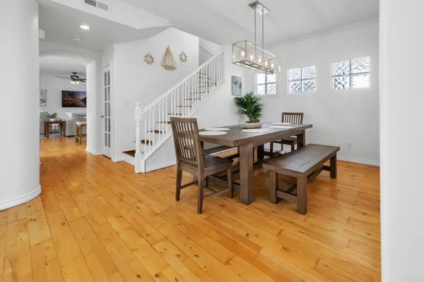 a view of a dining room with furniture and a chandelier