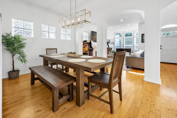 a view of a dining room with furniture and wooden floor