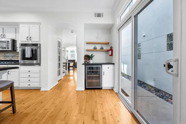a kitchen with stainless steel appliances a refrigerator and a stove top oven