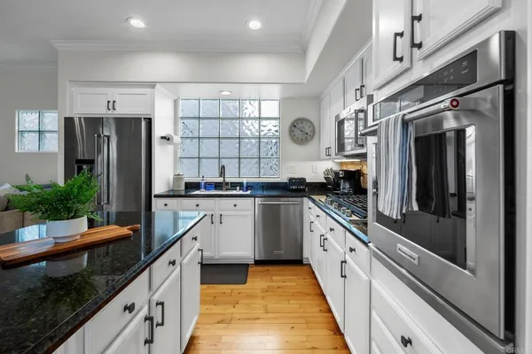 a kitchen with granite countertop stainless steel appliances and counter space