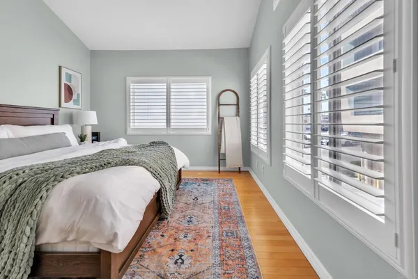 a bed sitting in a bedroom next to a window