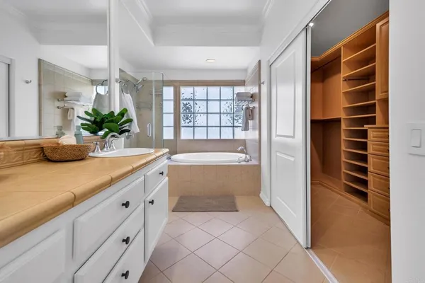 a bathroom with a tub sink and mirror