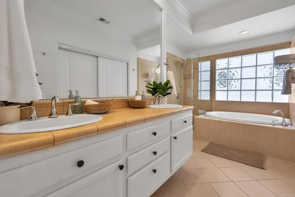 a spacious bathroom with sinks mirror and a bathtub