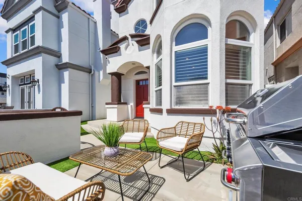 a view of a patio with couches table and chairs and potted plants
