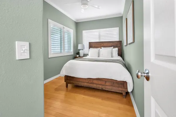 a bedroom with a bed and a chandelier