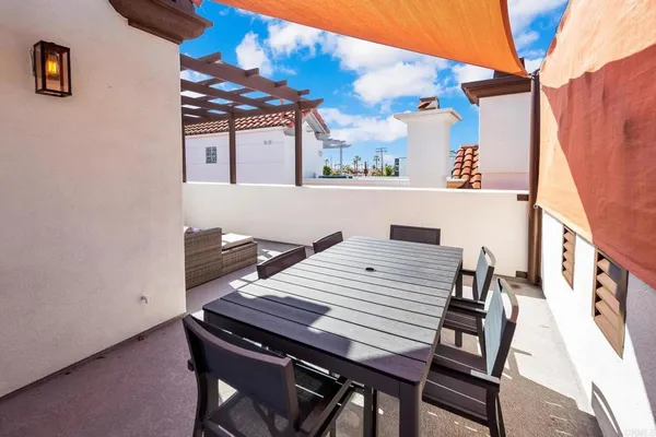 a view of a patio with table and chairs with wooden floor and fence
