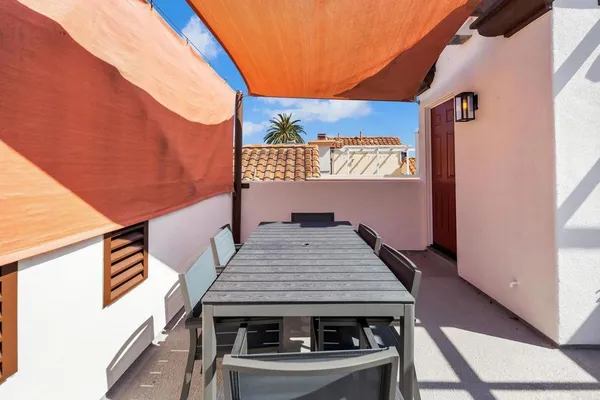 a view of a balcony with wooden floor and fence