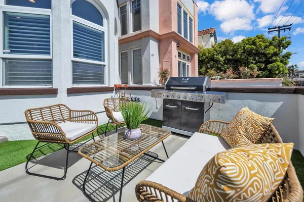 a view of a patio with couches chairs and a potted plant