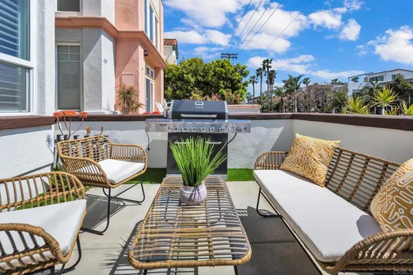 a view of a chairs and table in the balcony