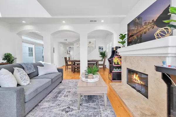 a living room with fireplace furniture and a wooden floor