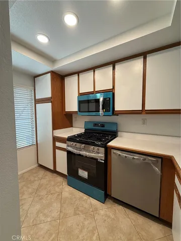 a kitchen with a sink stove and refrigerator