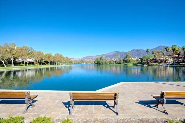 a view of a swimming pool with a patio and a yard