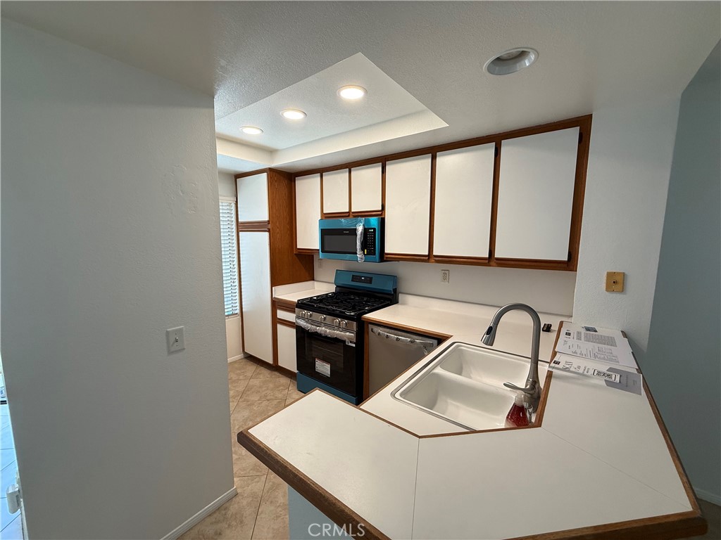 57 Rabano Rancho Santa Margarita, CA 92688 - Photo 3 of 29 a kitchen with a sink stove and refrigerator