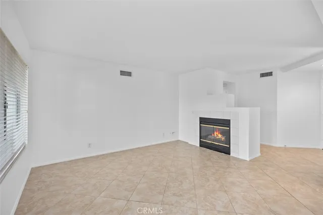 a view of a kitchen with a sink oven cabinets and a refrigerator