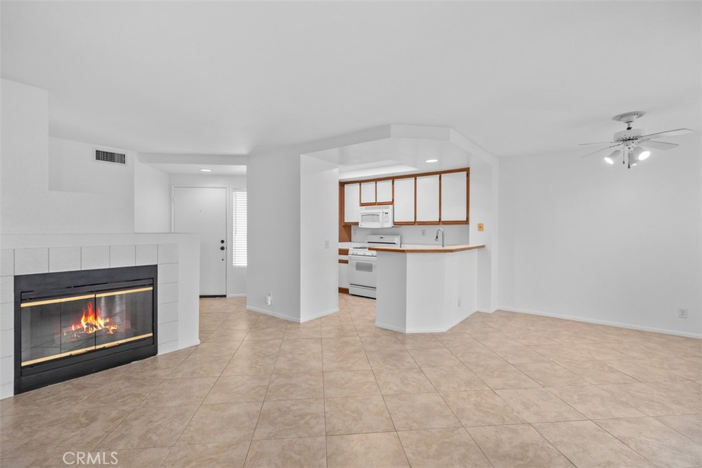 57 Rabano Rancho Santa Margarita, CA 92688 - Photo 6 of 29 a view of kitchen and empty room with fireplace