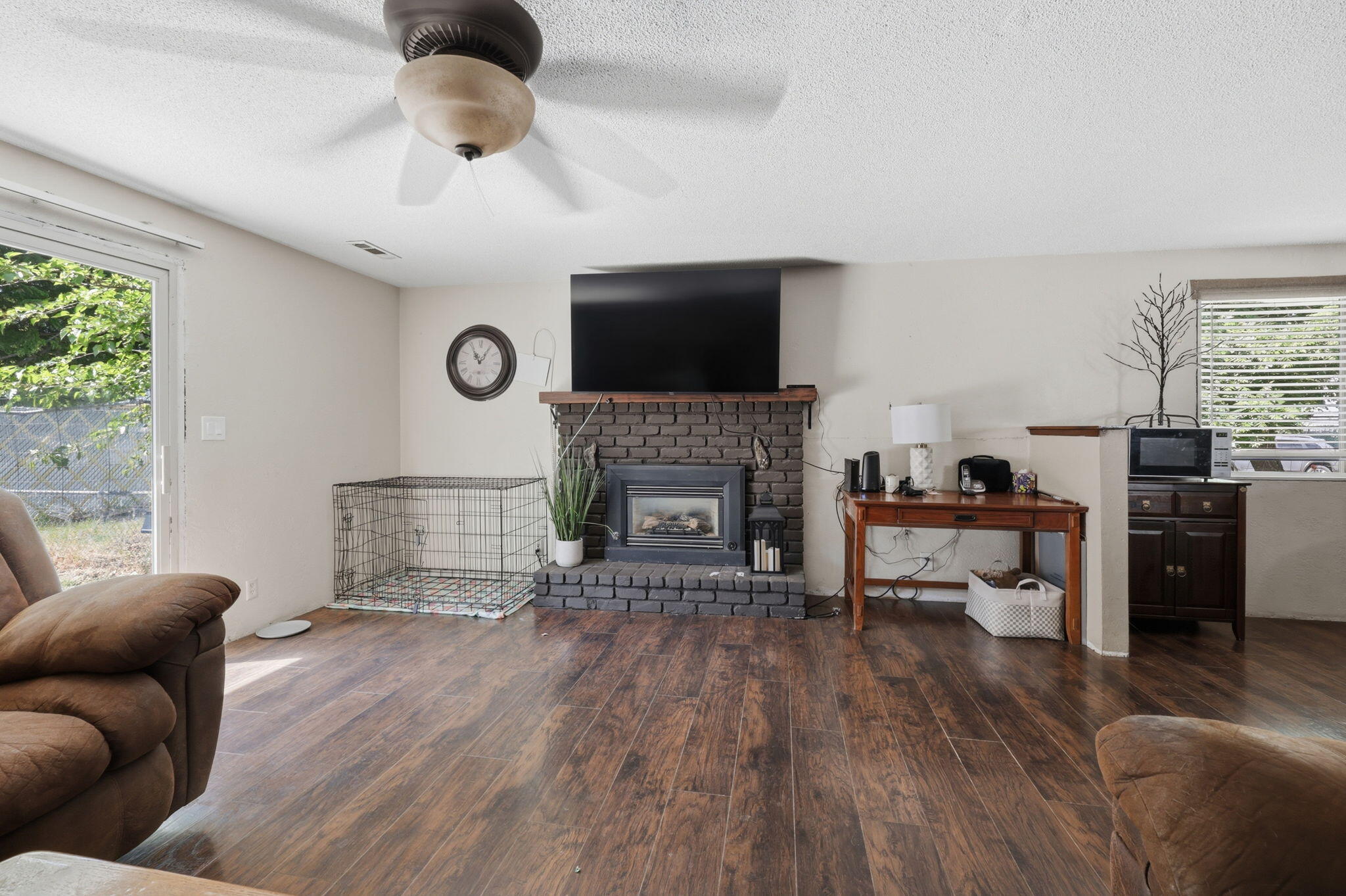 102 Elm Street Phoenix, OR 97535 - Photo 11 of 28 a living room with furniture a flat screen tv and a fireplace