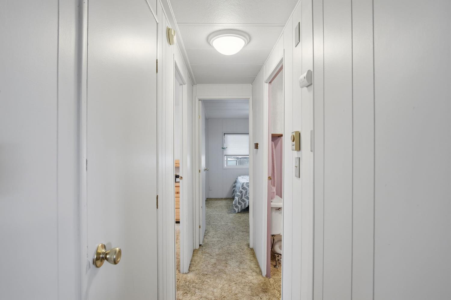 1400 Meredith Avenue, Unit 55 Gustine, CA 95322 - Photo 13 of 19 a view of a hallway with wooden floor closet and mirror