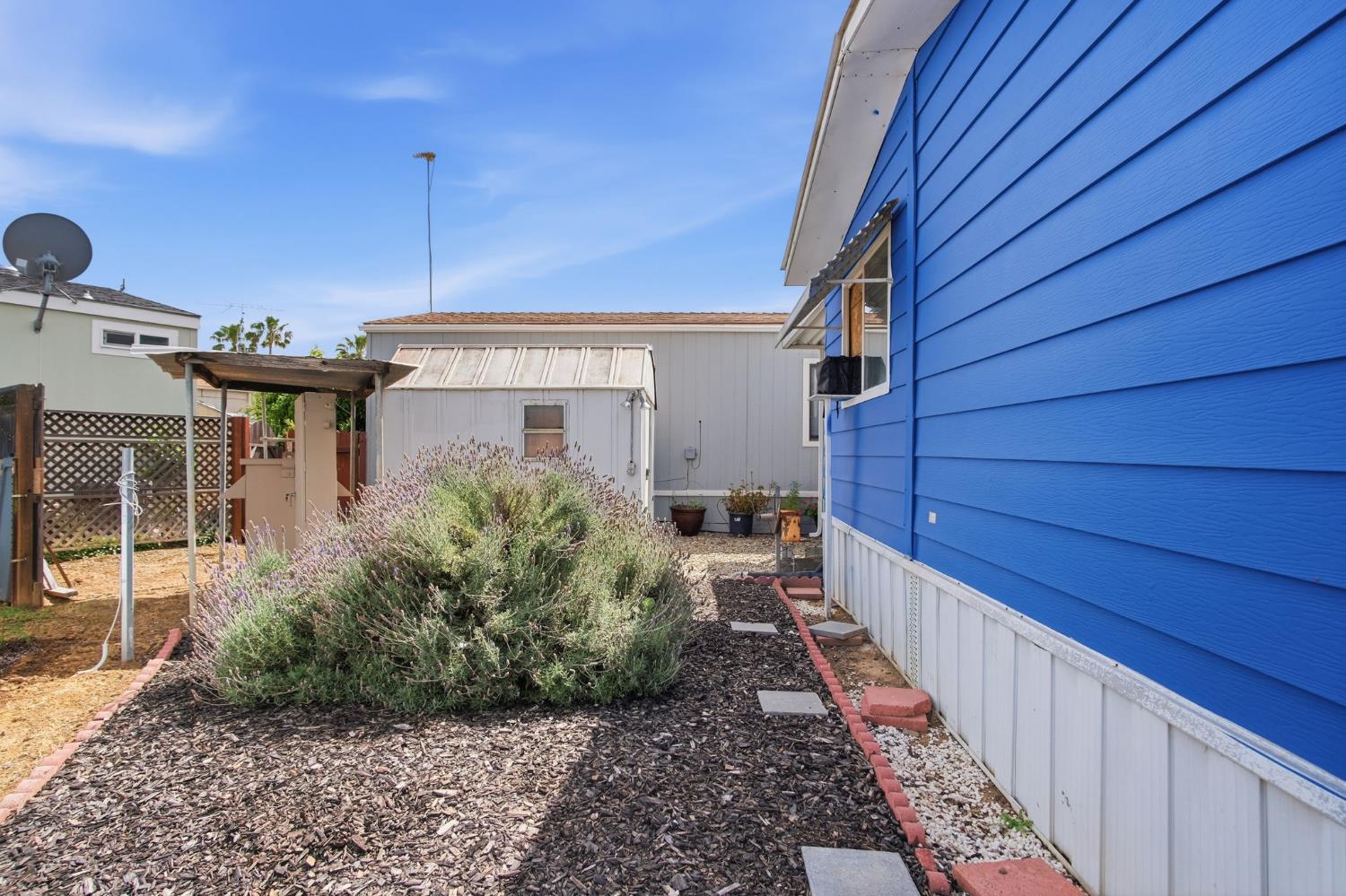 1400 Meredith Avenue, Unit 55 Gustine, CA 95322 - Photo 19 of 19 a view of a house with a backyard