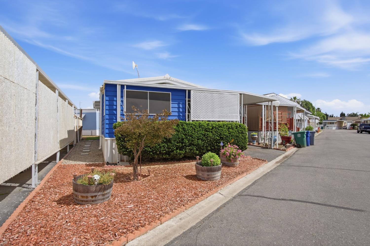 1400 Meredith Avenue, Unit 55 Gustine, CA 95322 - Photo 2 of 19 a front view of a house with garden