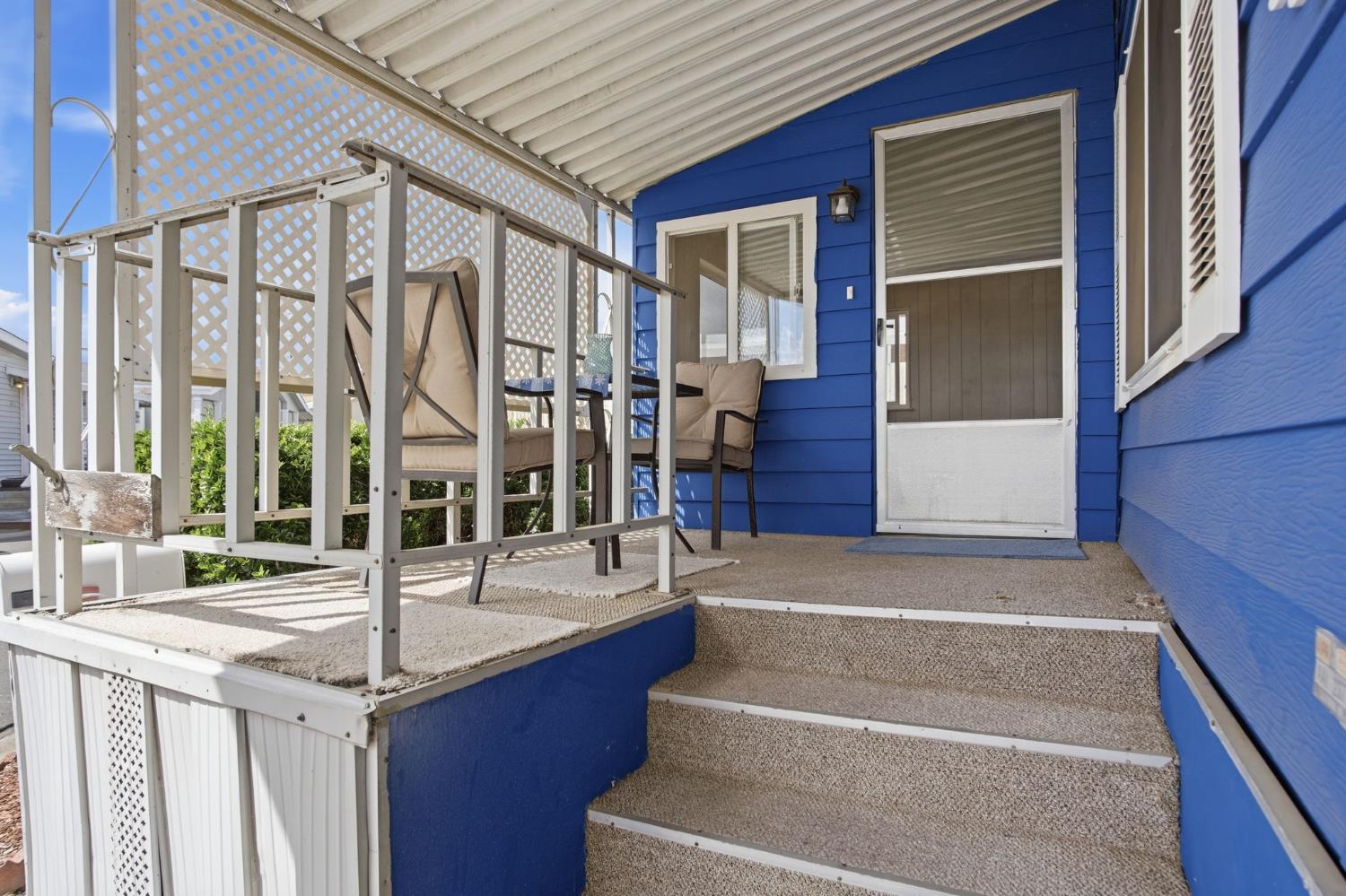 1400 Meredith Avenue, Unit 55 Gustine, CA 95322 - Photo 4 of 19 a front view of a house with large windows and entryway