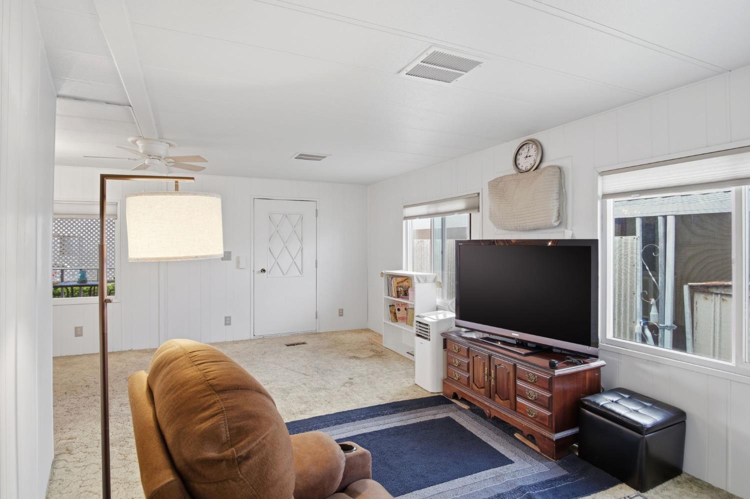 1400 Meredith Avenue, Unit 55 Gustine, CA 95322 - Photo 6 of 19 a living room with furniture and a flat screen tv
