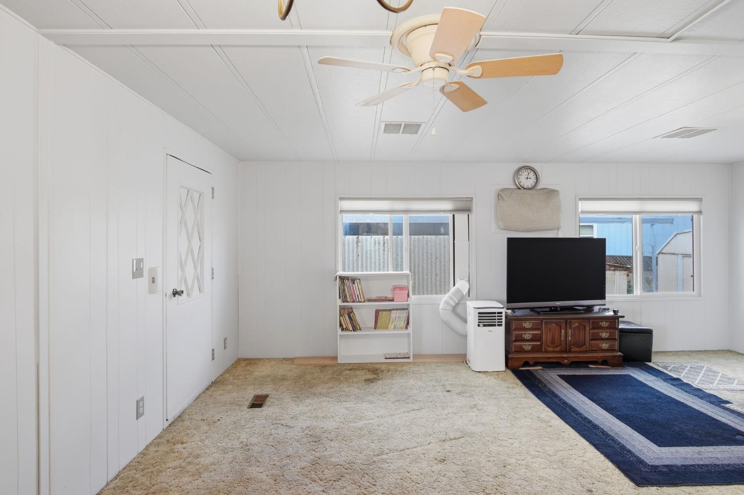 1400 Meredith Avenue, Unit 55 Gustine, CA 95322 - Photo 7 of 19 a living room with furniture and a flat screen tv