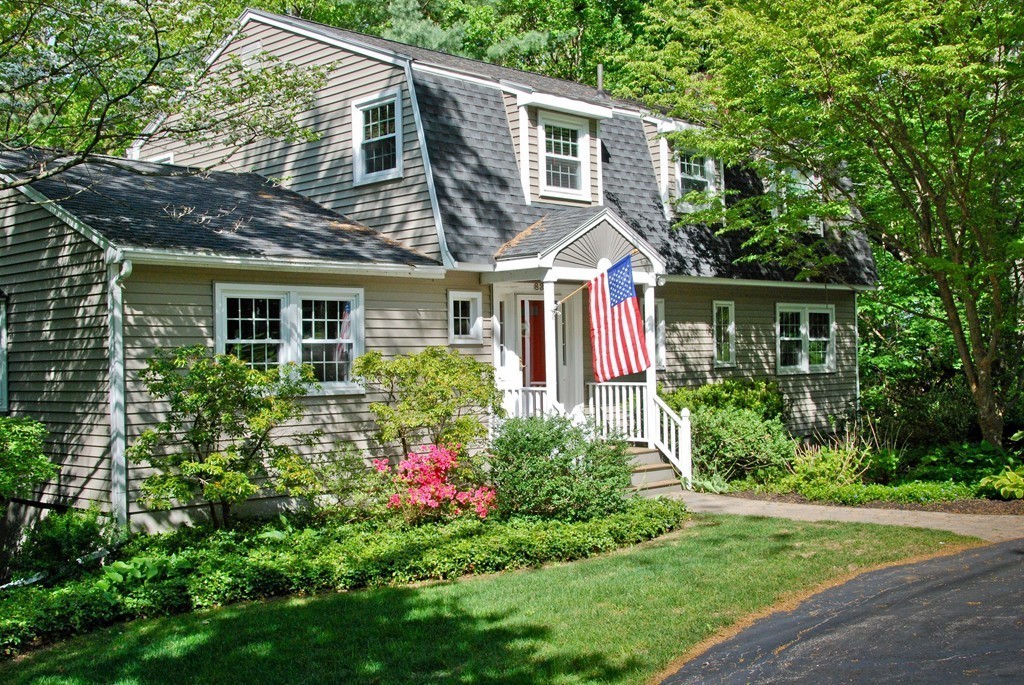 83 Concord Road Acton, MA 01720 - Photo 1 of 30 a view of a house with brick walls and a yard with plants