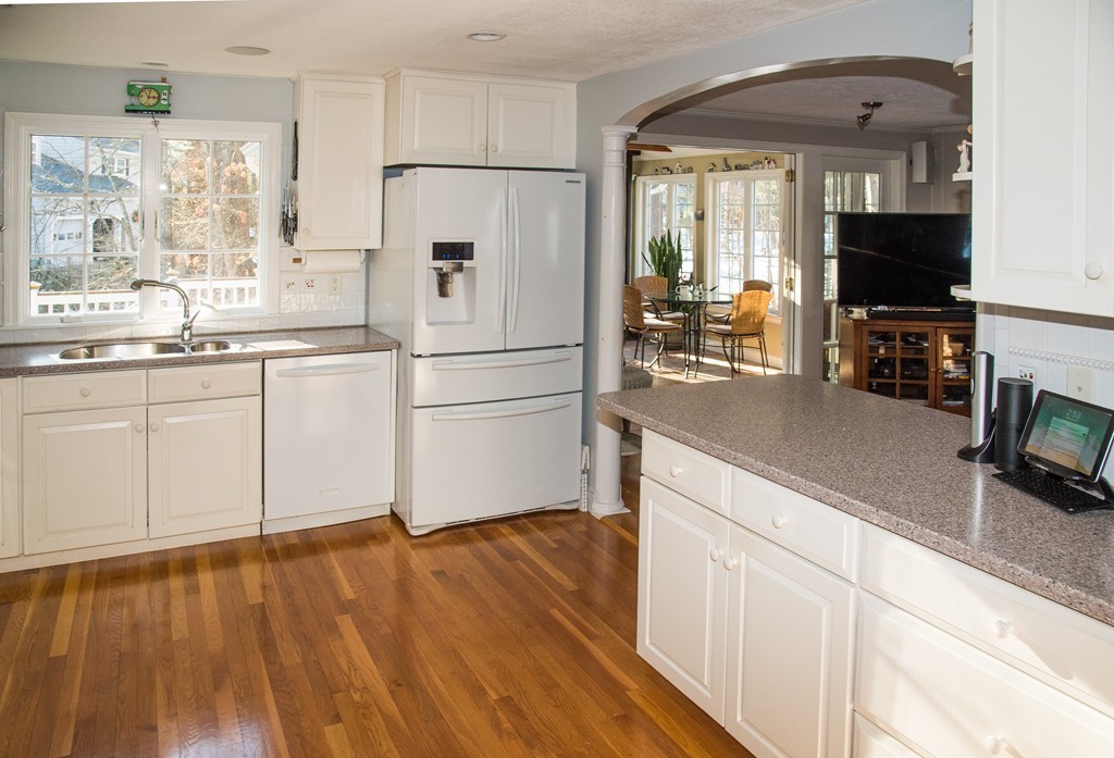 83 Concord Road Acton, MA 01720 - Photo 11 of 30 a kitchen with stainless steel appliances white cabinets and wooden floor