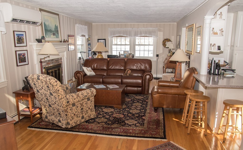 83 Concord Road Acton, MA 01720 - Photo 12 of 30 a living room with fireplace furniture and a window