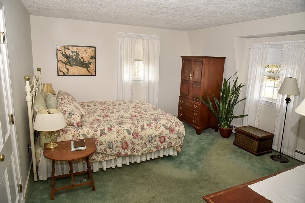 83 Concord Road Acton, MA 01720 - Photo 19 of 30 a bed sitting in a room next to a window