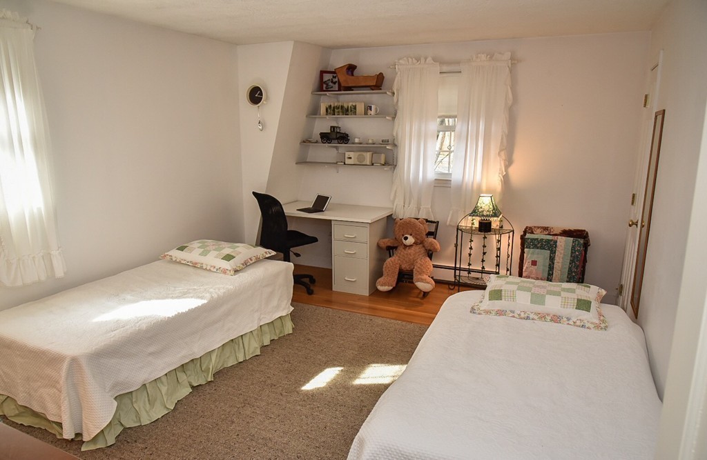 83 Concord Road Acton, MA 01720 - Photo 23 of 30 a bed room with a bed and a chair