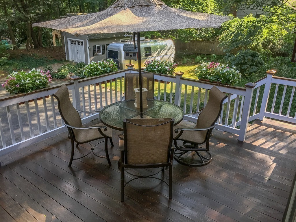 83 Concord Road Acton, MA 01720 - Photo 24 of 30 a view of a chair and table on the deck
