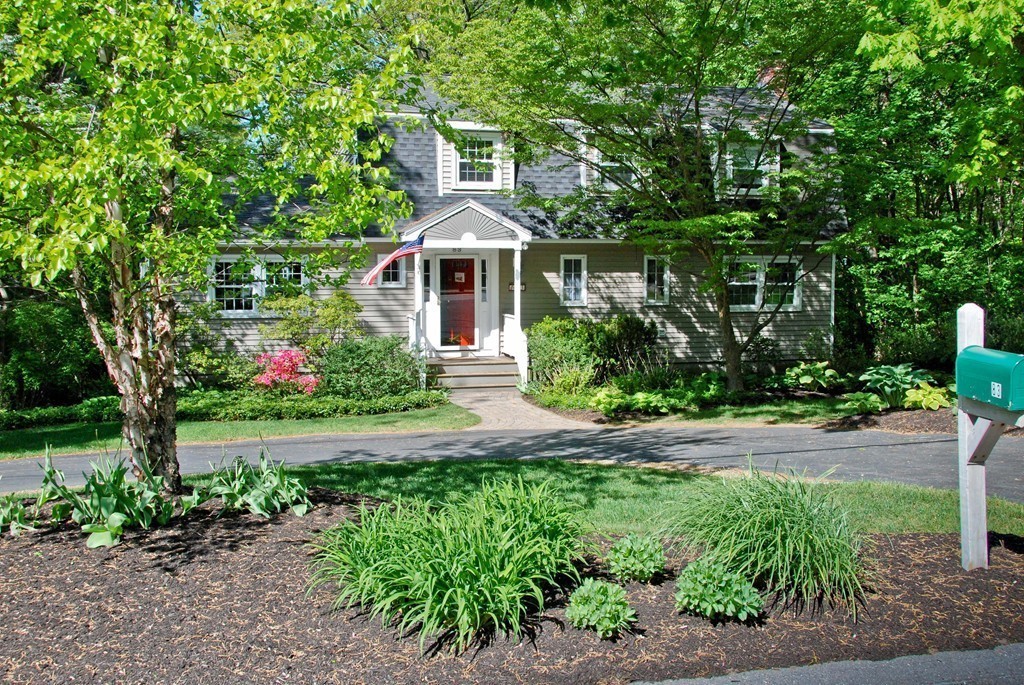 83 Concord Road Acton, MA 01720 - Photo 29 of 30 a front view of a house with a yard and shrubs