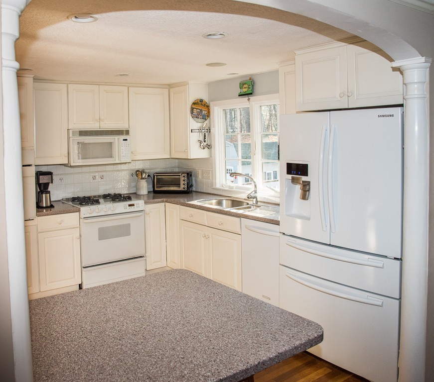 83 Concord Road Acton, MA 01720 - Photo 10 of 30 a kitchen with white cabinets and white appliances
