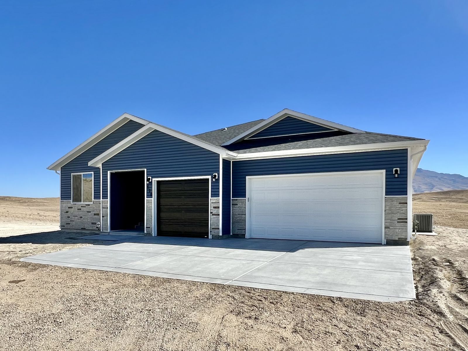 518 Ridgeway Drive Spring Creek, NV 89815 - Photo 1 of 37 a front view of a house with a yard and garage