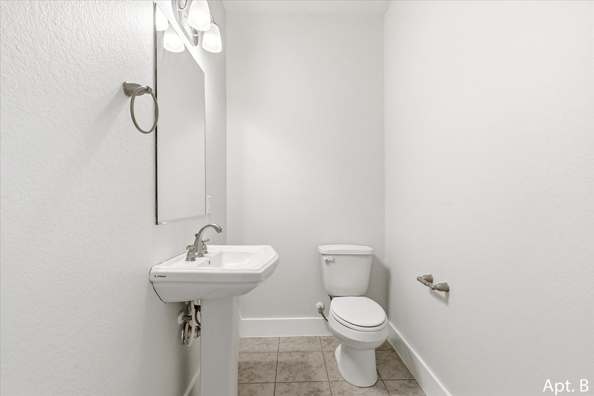 2225 Katy Lane, Unit B Georgetown, TX 78626 - Photo 21 of 22 a bathroom with a sink toilet and mirror