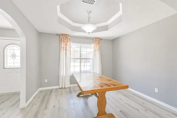 a view of a room with wooden floor and windows