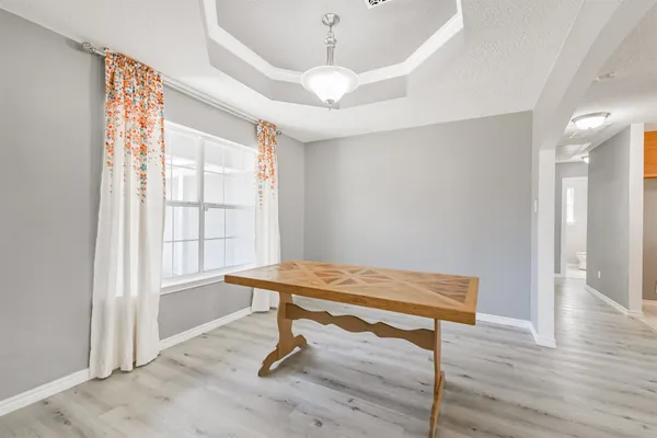 a view of a room with wooden floor wooden floor and windows