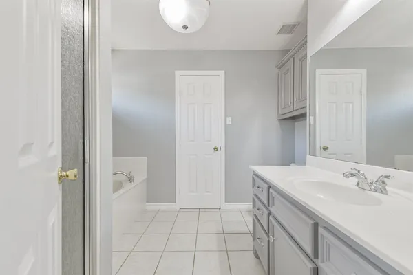 a spacious bathroom with a sink a mirror and a shower
