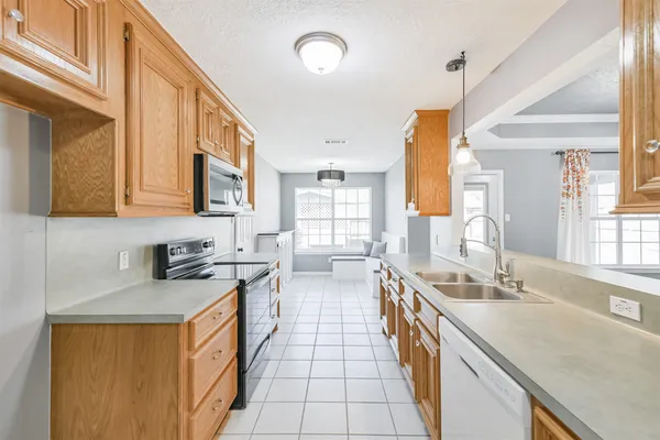 a kitchen with stainless steel appliances a sink stove and cabinets