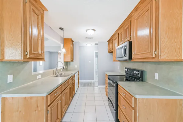 a kitchen with stainless steel appliances granite countertop a sink and cabinets