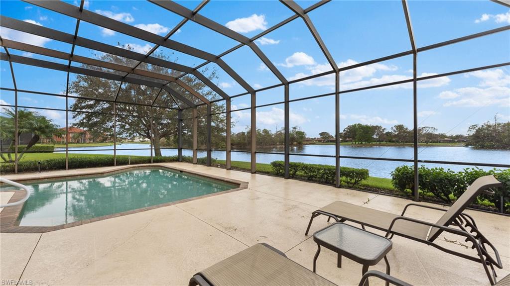 6172 Dogleg Drive Naples, FL 34113 - Photo 11 of 45 a view of a swimming pool with a yard