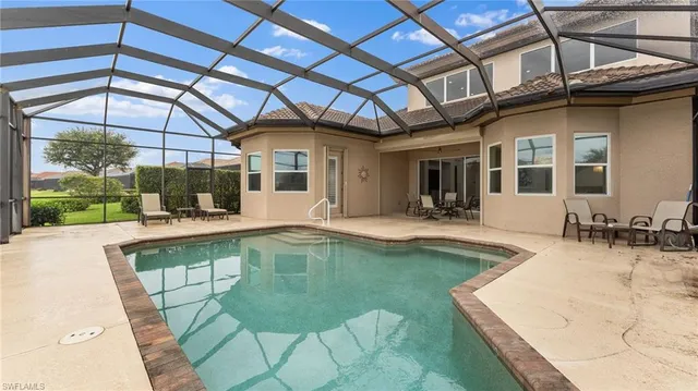 a swimming pool with outdoor seating