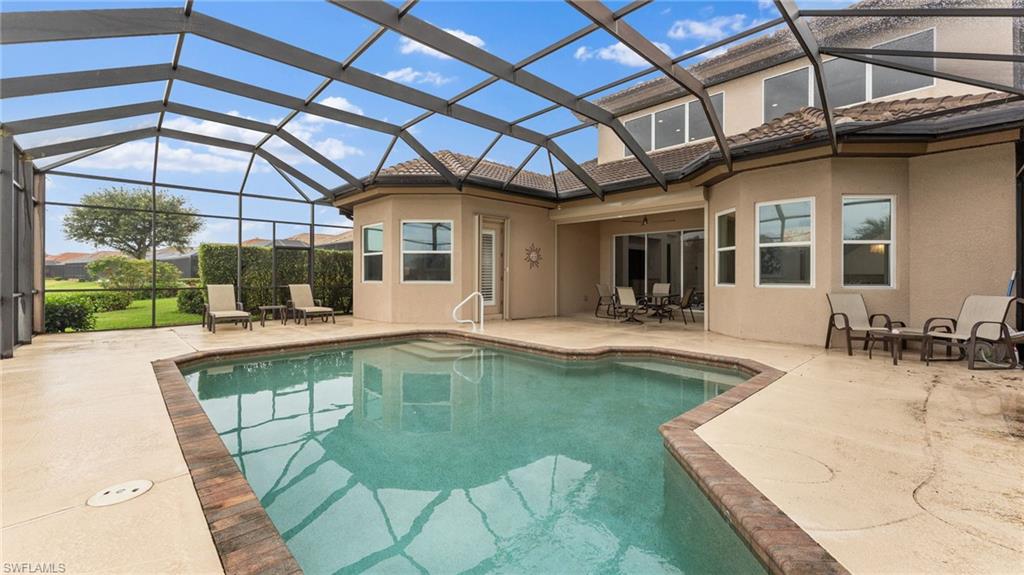 6172 Dogleg Drive Naples, FL 34113 - Photo 12 of 45 a swimming pool with outdoor seating