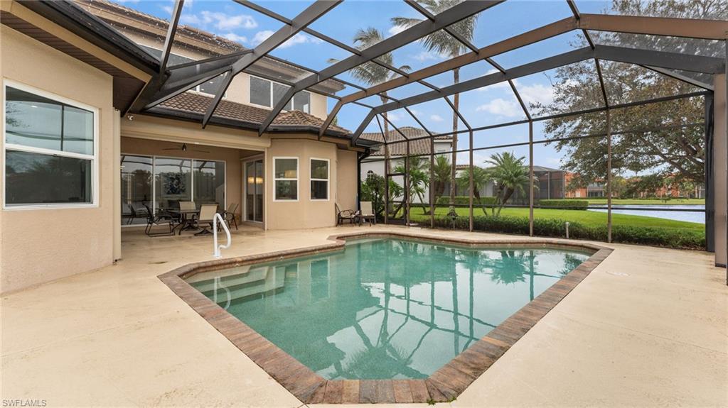 6172 Dogleg Drive Naples, FL 34113 - Photo 14 of 45 a view of a swimming pool with a patio