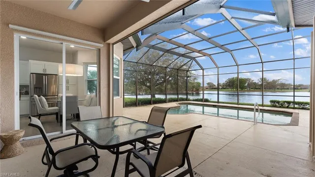 a view of a dining room with furniture water view and large windows