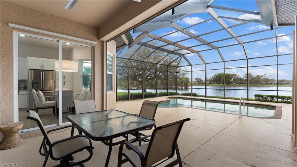 6172 Dogleg Drive Naples, FL 34113 - Photo 15 of 45 a view of a dining room with furniture water view and large windows