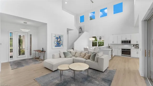 a view of a dining room with furniture and a chandelier