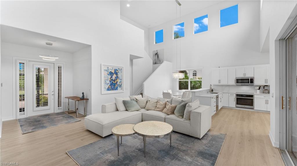 6172 Dogleg Drive Naples, FL 34113 - Photo 17 of 45 a living room with furniture and a table